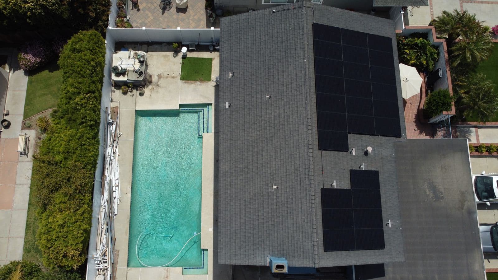Overhead view of rooftop solar next to a swimming pool