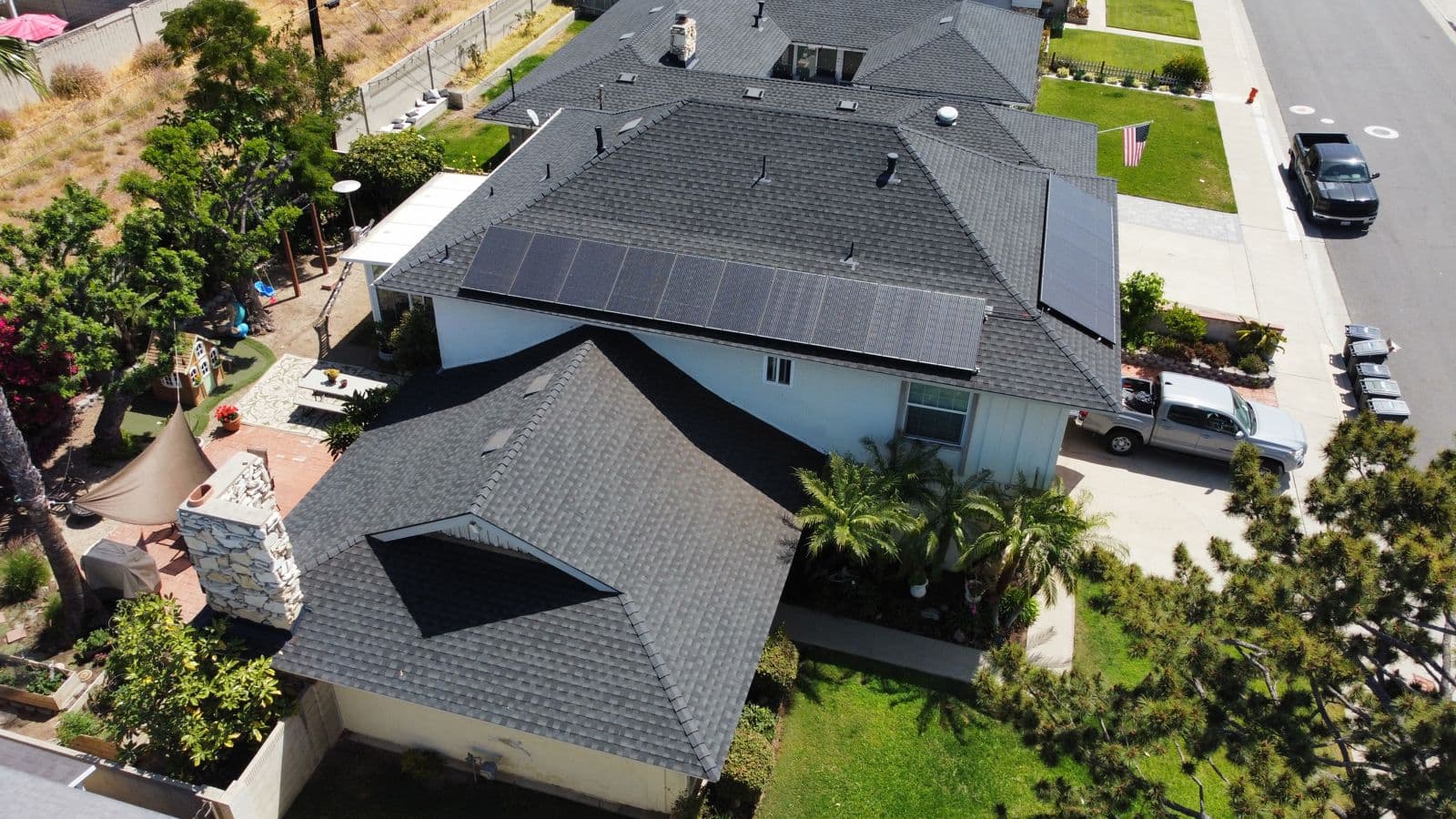 Aerial view of a California tile-roof home with a full rooftop solar array